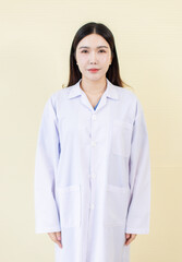 Studio portrait of attractive cheerful asian female doctor wearing white lab coat uniform stand confident against soft light background represent healthcare expert medical professional modern medicine