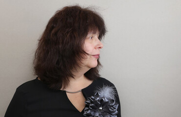 Studio portrait in profile of an elderly beautiful woman.