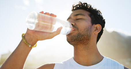 Below, man and drinking water for fitness outdoor for hydration, nutrition and exercise break. Male...