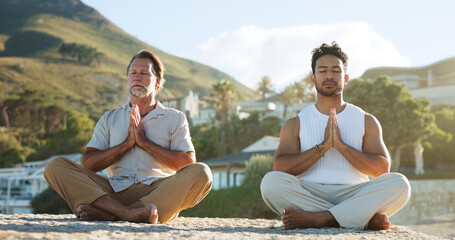 Beach, yoga and men with prayer hands, meditation and nature for health benefits. Outdoor, people and yogi with balance, zen and chakra with routine, hobby and spiritual wellbeing with mudra on sand