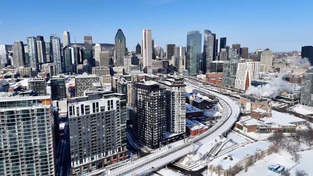 Downtown Montreal skyline with modern skyscrapers and winter cityscape under clear blue sky, Quebec, Canada. g.