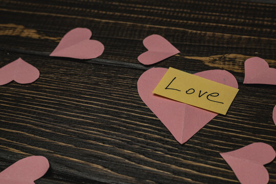 Hearts and love notes on a wooden table