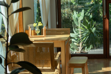 Cafe interior with wooden tables and small plants