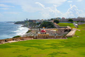 Obraz premium The iconic red-domed chapel of Santa Maria Magdalena de Pazzis Cemetery in fronf of La Perla neighborhood by the Atlantic Ocean in Old San Juan, Puerto Rico