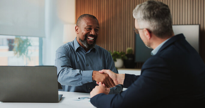 Shaking hands, collaboration and business men in office for finance partnership, agreement or deal. Happy, meeting and male financial advisor with client for investment contract with handshake.