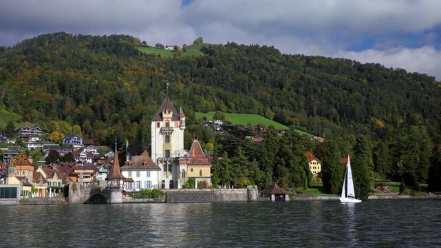 Castle Oberhofen Schloss Oberhofen am Thunersee sailboat Fall Autumn sunny morning clouds aerial drone Thun Switzerland Schweiz Swiss Alps town Bernese Oberland Interlaken calm water pan