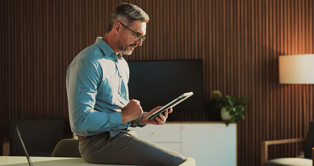 Tablet, research and mature businessman in office for finance report with budget review. Digital...