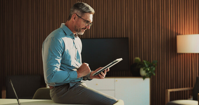 Tablet, research and mature businessman in office for finance report with budget review. Digital technology, reading and male financial manager with email for investment proposal in workplace.