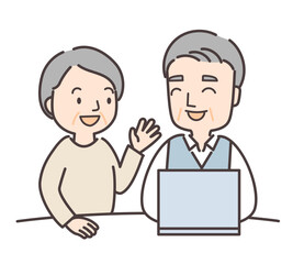 パソコンの前で会話するシニア夫婦