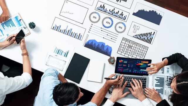 Team collaborating on data analysis using laptop and charts, highlighting graphs and statistics for effective decision-making and business growth strategies Gluon.