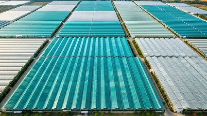 A collection of corrugated metal sheets in various shades of green and gray neatly arranged in rows