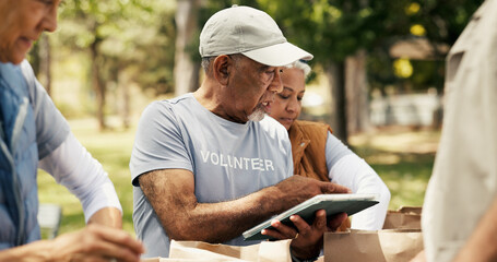 Mature man, volunteer and tablet outdoor for charity, online checklist and community service. People, parcel and digital with donation inventory, humanitarian outreach and ngo schedule for food drive