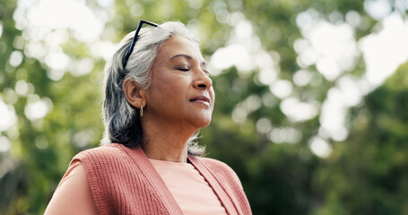Thinking, walk or old woman in park with breath, fresh air or reflection in retirement hobby. Wellness, bokeh or female person in nature with stroll, daydreaming or mindfulness in senior activity.