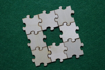 Nine wooden puzzle pieces arranged in a square