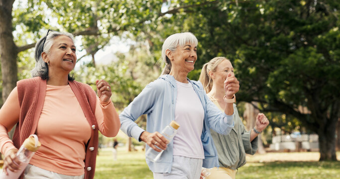Fitness, walking and senior women in park with smile, retirement exercise or training for health. Personal trainer, outdoor workout or elderly people with water bottle for wellness, active or cardio