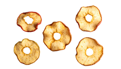 Close-up of five dried apple slices on a black background, showcasing texture