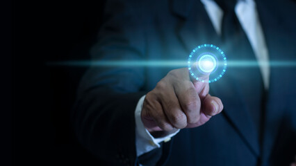 Businessman Finger Pointing at Holographic Interface Element on a dark Background. The future abstract technology innovation concept