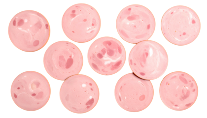 Overhead shot of eleven pink, circular luncheon meat slices arranged on black
