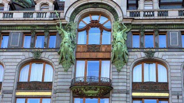 The Singer company's house in St. Petersburg on Nevsky Prospekt. A historic Art Nouveau building. Metal frame, bay windows and turrets decorated with sculptures of valkyries. A glass globe on the roof