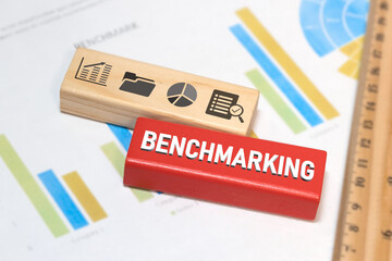 Concept of benchmarking and collecting data for further data analysis created with wooden blocks and graphic icons.