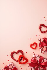 Vertical Valentine's Day background with hearts and presents on pink table.