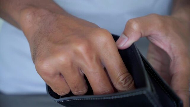 Person Checking Empty Wallet for Financial Hardship