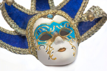 closeup on the face of decorative Venetian porcelain mask isolated on a white background