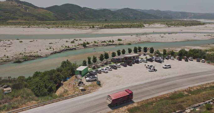 Vjosa River Albania Aerial v9 low flyover around the coffee shop capturing turquoise waters weaving through pristine sands, and forested hillside views - Shot with Mavic 3 Pro Cine - July 12th 2024