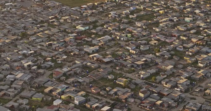 Cape Town South Africa Aerial v103 zoomed flyover and around Khayelitsha township, capturing overcrowded informal settlements in the area at sunset - Shot with Mavic 3 Pro Cine - Jan 11th 2024