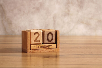 February 20th, date of event or birthday.  wooden perpetual calendar made of cubes and an empty space for your text.