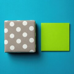 Polka-dot gift box and lime square on bright blue
