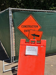 CONSTRUCTION ENTRANCE sign on a temporary fence