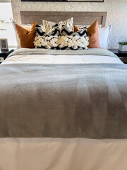 Cozy Bed With Gray Throw And Accent Pillows