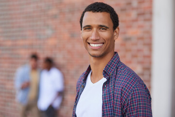 Portrait, student and man at university, happy or confident with scholarship, learning and education. Outdoor, learner and person with knowledge for growth, college and funding opportunity for course