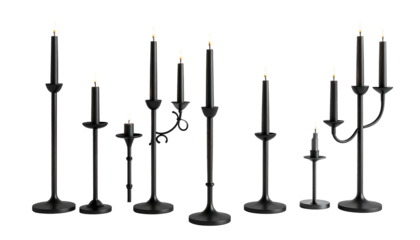 A collection of black candlesticks of varying heights with lit candles on a black background