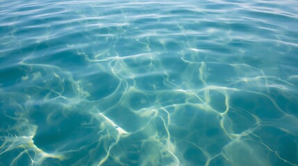 Calming ocean water surface with sunlight reflections
