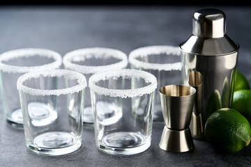 Concept of preparing Margarita Cocktail, shaker,lime. preparing and serving a classic margarita cocktail.