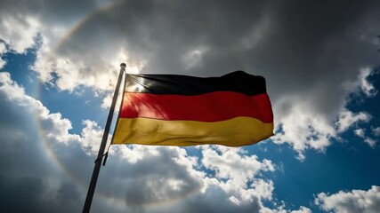 German flag waving in sunlit sky with atmospheric halo effect
