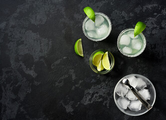 Margarita cocktail with lime and ice cubes, top view.