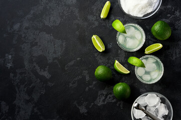 Margarita cocktail with lime and ice cubes, top view.