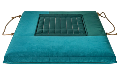 Turquoise padded square cushion with a central dark green sunken section and rope handles