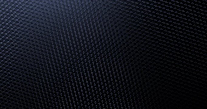 View of  carbon weave with subtle metallic sheen gently shifting in a high-tech repeating pattern.