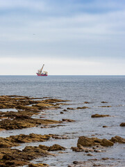 Offshore crane construction vessel working near Wick coastline
