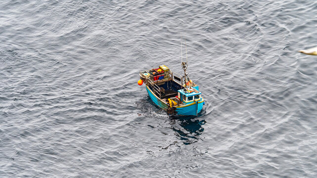 Fishing boat floating on ocean water in Thurso, Scotland
