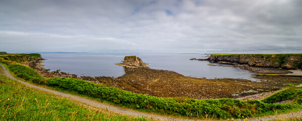 Thurso bay coastline view with sea stack and winding path in Scotland