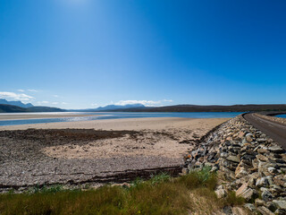 Kyle of Tongue causeway spanning Scottish Highlands estuary on sunny day