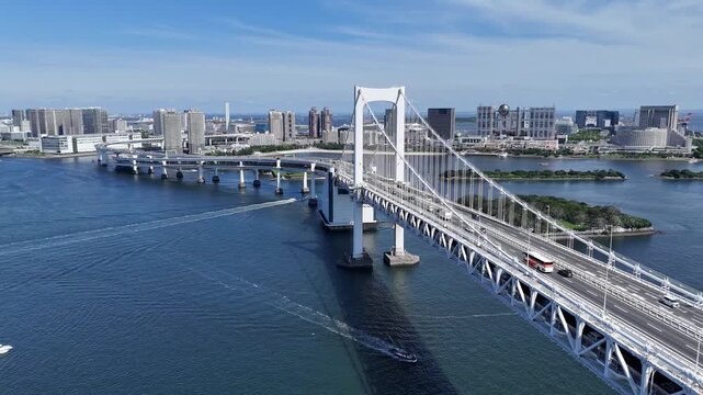 Rainbow Bridge spanning Tokyo Bay with Odaiba high-rise buildings in background 