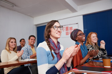 Students, applause and smile in university class for feedback, knowledge or celebration. Group, people and clapping hands for answer with college, learning and pupil in lecture or scholarship