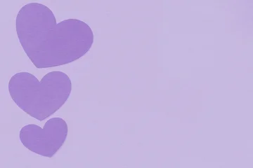 Fotobehang Lilac Purple hearts on a lilac background with paper texture, card, template, message, greeting, copy space for text  © AlmerGungor