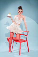 Elegant Asian beauty celebrates 30th birthday in white lace halter crop top and ruffled mini skirt with red ribbons, holding red velvet cake, wearing red heart glasses and cherry earrings, glamorous 